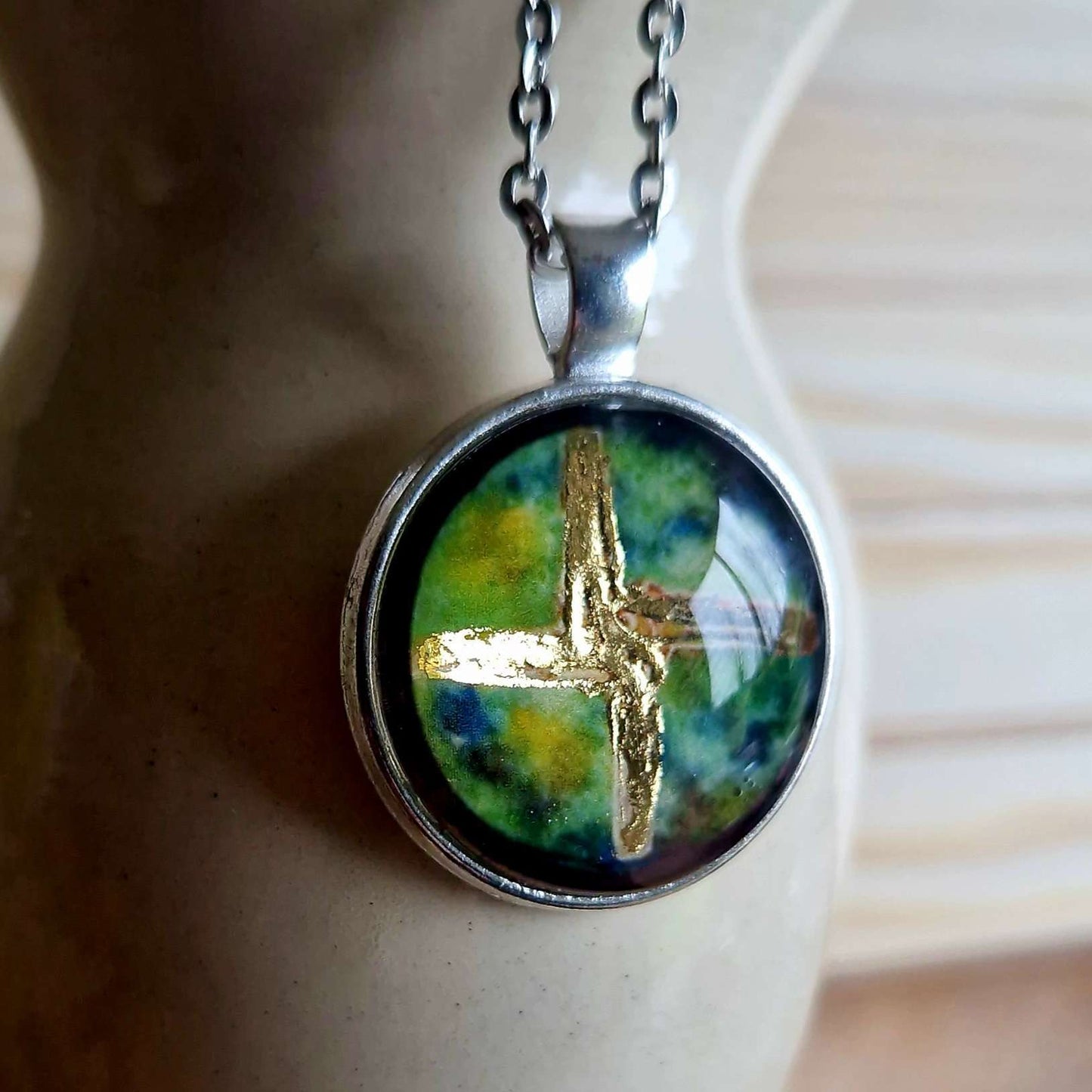 St brigid cross celtic designed necklace, featuring original painting finished with gold leaf. Irish themed art jewellery. Stainless steel chain